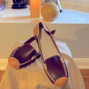 Brown/tan leather suede loafers with gold trim detail stitching. Never been worn